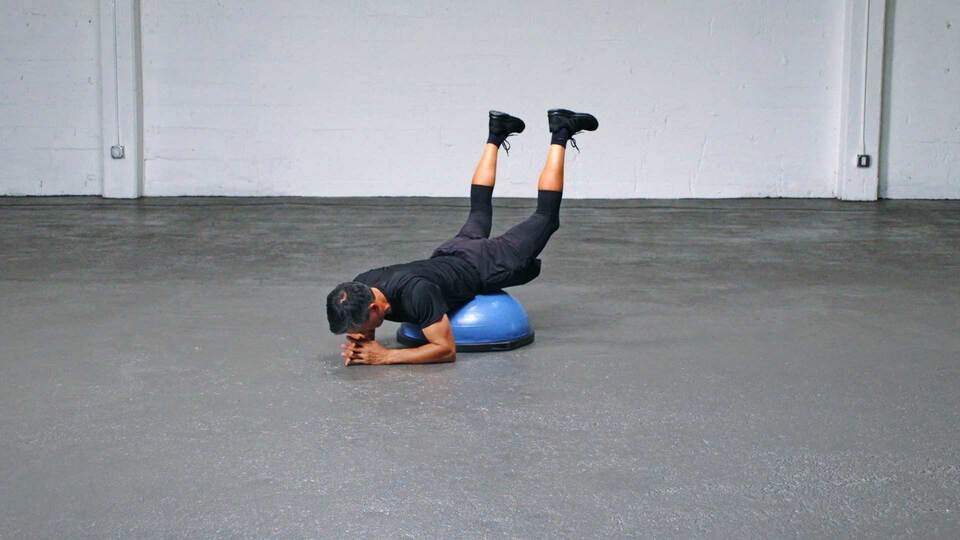 Man doing BOSU Ball Reverse Hyperextension