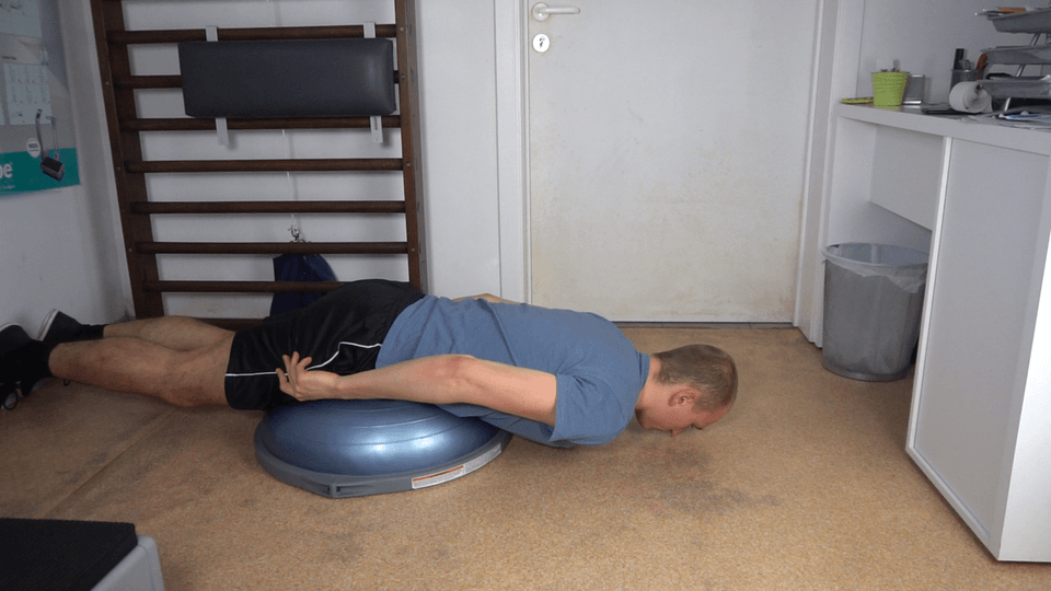 Man doing Bosu Back Extensions