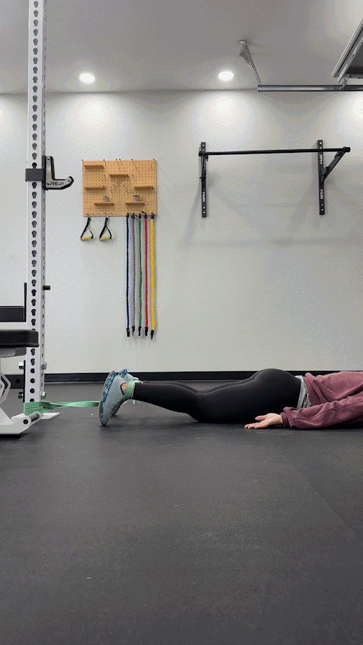 Woman is doing Prone Banded Leg Curl
